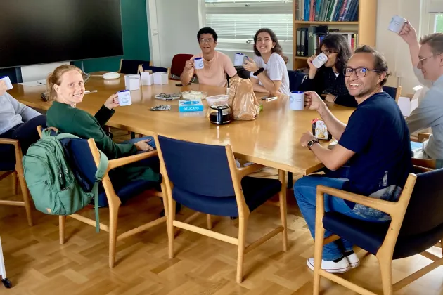 Students sitting around a table ready to go to work.